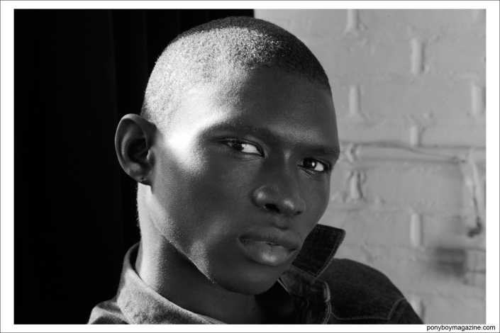 A male model waiting to get his makeup done at the Duckie Brown Autumn/Winter 2014 show at Industria Studios in New York City. Photographed for Ponyboy Magazine by Alexander Thompson.