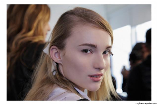 Portrait of a blonde model during hair and makeup, backstage at Timo Weiland A/W 2014 Collection in New York City. Photographed at Milk Studios for Ponyboy Magazine by Alexander Thompson.