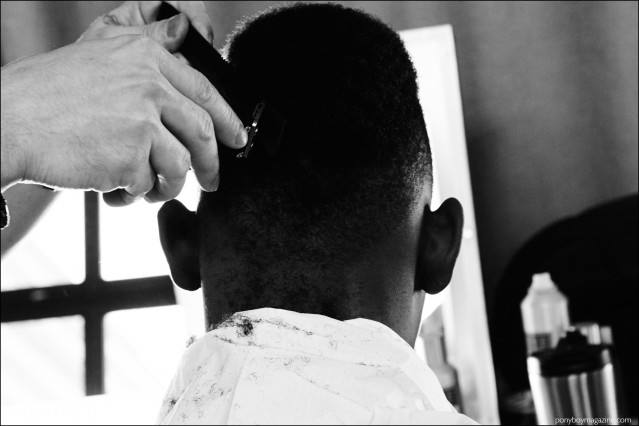 Male model Youssouf Bamba gets a buzz cut, backstage at Duckie Brown F/W16 menswear show. Photography by Alexander Thompson for Ponyboy magazine.