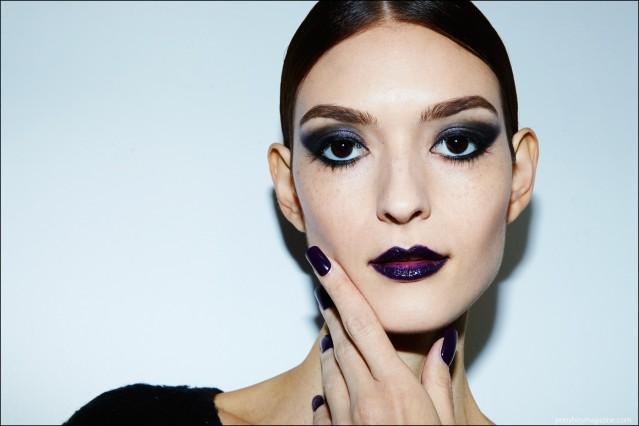 Beauty shot of a model with purple eyeshadow, lips and nails. Photographed backstage at Georgine F/W16 womenswear show by Alexander Thompson for Ponyboy magazine.