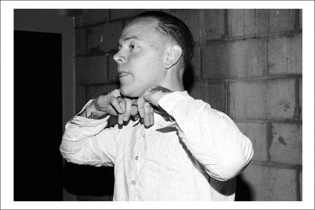 Musician C.W. Stoneking adjusts his bowtie while being photographed by Alexander Thompson for Ponyboy magazine.