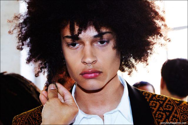 An afro gets styled backstage at David Hart S/S17 menswear show. Photography by Alexander Thompson for Ponyboy magazine.