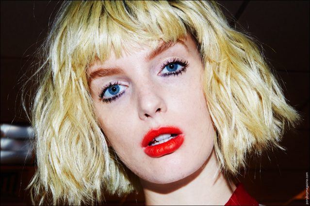 A close-up shot of a model in her blonde bob wig, backstage at the Georgine S/S17 show. Photography by Alexander Thompson for Ponyboy magazine.