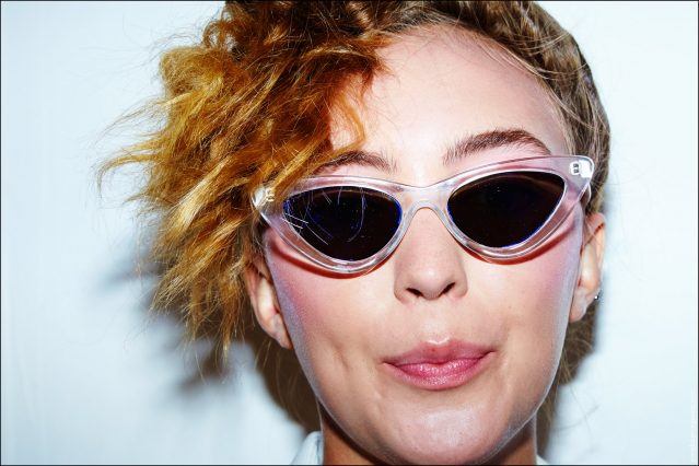 A model snapped in cat-eye sunglasses, backstage at the Spring/Summer 2017 show for designer Adam Selman. Photographed by Alexander Thompson for Ponyboy magazine.