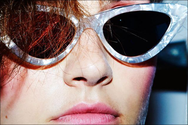 A close-up shot of a model in cat-eye sunglasses, backstage at Adam Selman S/S17. Photography by Alexander Thompson for Ponyboy magazine in New York City.