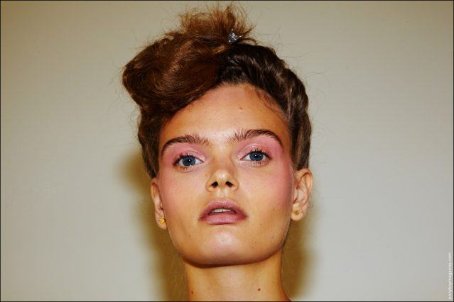 A model poses for the camera, backstage at the Adam Selman Spring/Summer 2017 show in New York City. Photographed by Alexander Thompson for Ponyboy magazine.