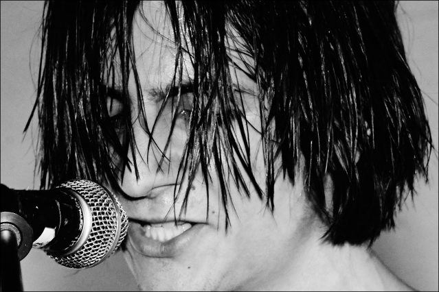 A close-up shot of Lemon Twigs musician Michael D'Addario at the mic, photographed by Alexander Thompson for Ponyboy magazine.