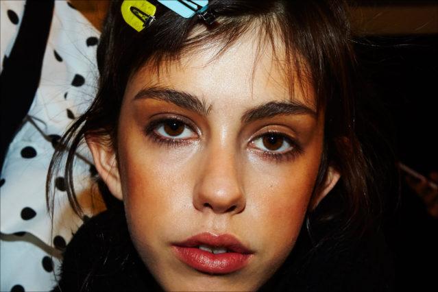 Model Mayka Merino snapped backstage in makeup at Adam Selman Fall 2017 womenswear show in New York. Photography by Alexander Thompson.