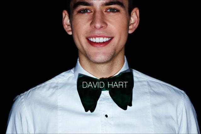 A smiling male model snapped backstage wearing a David Hart bowtie and tuxedo shirt for Fall/Winter 2017. Photography by Alexander Thompson for Ponyboy magazine NY.