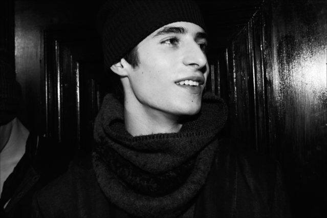 Model Oscar Kindelan wears a wool scarf and knit cap backstage at John Varvatos F/W17 menswear show. Photographed by Alexander Thompson for Ponyboy magazine.
