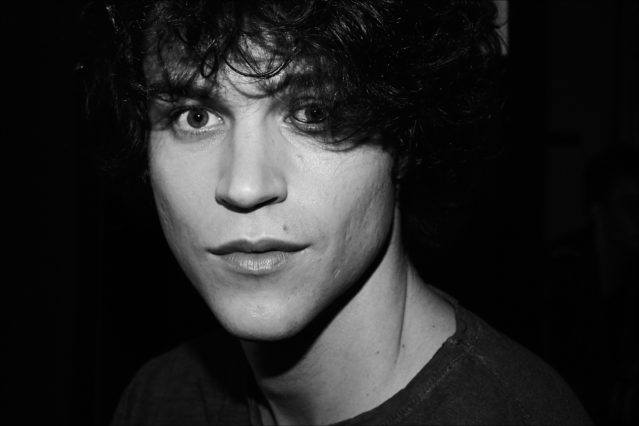 Model Mile McMillan photographed in hair & makeup, backstage at the John Varvatos Fall/Winter 2017 menswear show. Photography by Alexander Thompson for Ponyboy magazine.
