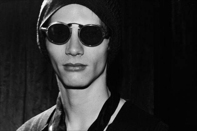 Male model Erik van Gils photographed in sunglasses backstage at the John Varvatos Fall/Winter 2017 menswear show. Photography by Alexander Thompson for Ponyboy magazine.