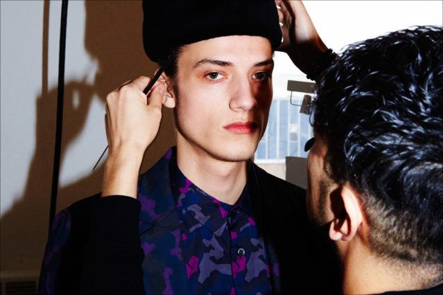 Male model Serge Rigvava photographed backstage in colorful camo for Robert Geller A/W17. Photography by Alexander Thompson for Ponyboy magazine NY.