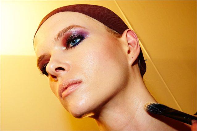 Model Alyona Subbotina gets her makeup applied, backstage at the Georgine Fall/Winter womenswear collection. Photographed by Alexander Thompson for Ponyboy magazine.