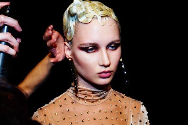 Model Milena Garbo with last minute hair touchups, backstage at The Blonds Fall 2017 womenswear collection. Photography by Alexander Thompson for Ponyboy magazine.