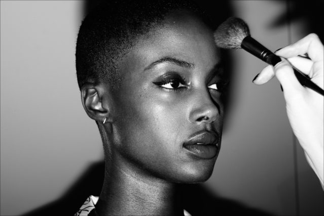 A female model gets her makeup touched up before the David Hart menswear show for Spring 2018. Photography by Alexander Thompson for Ponyboy magazine.