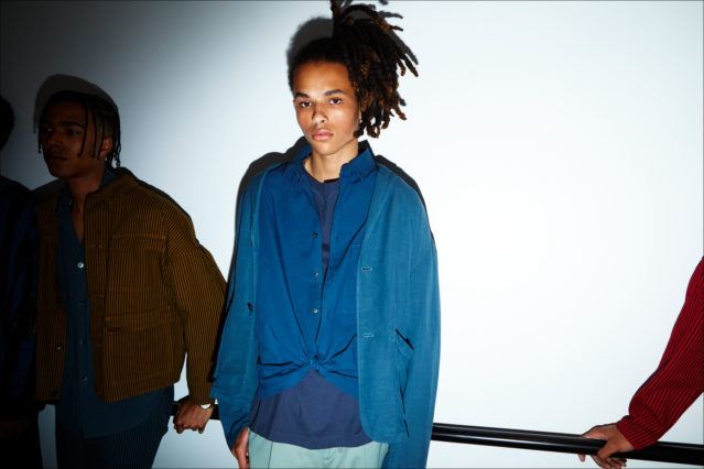A dreaded male model backstage at Gustav Von Ashcenbach Spring 2018 menswear show by designer Robert Geller. Photographed by Alexander Thompson for Ponyboy magazine.