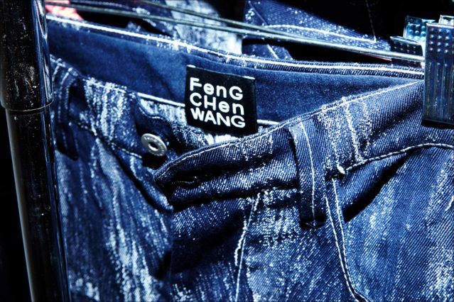 Closeup of jeans backstage at the Feng Chen Wang menswear show. Photographed by Alexander Thompson for Ponyboy magazine.
