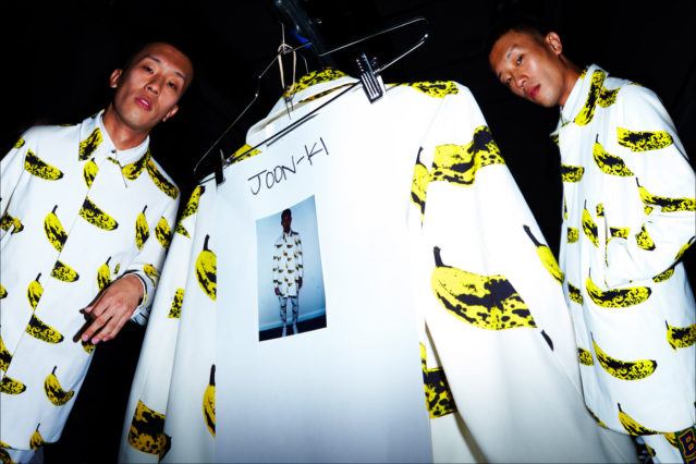 A male model photographed in a banana print trench coat by Libertine, for Spring/Summer 2018. Backstage photography by Alexander Thompson for Ponyboy magazine.