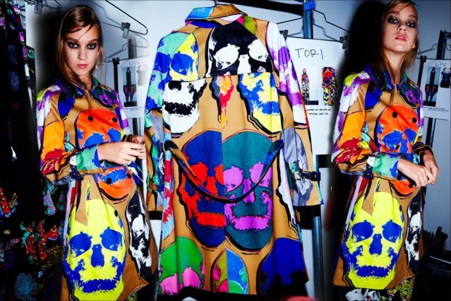 Model Tori wears a day-glo skull trench coat. Photographed backstage at Libertine S/S18 show by Alexander Thompson for Ponyboy magazine.