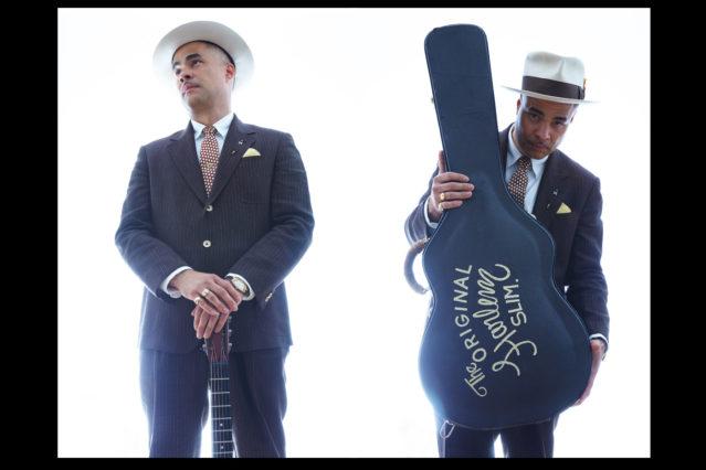 B&W portrait of "The Original Harlem Slim" with guitar, musician Tito Deler. Photographed in New York City for Ponyboy magazine by Alexander Thompson.