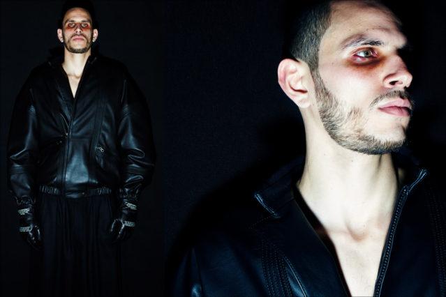 A male model in black leather poses backstage at Willy Chavarria for Fall 2018. Photography by Alexander Thompson for Ponyboy magazine.