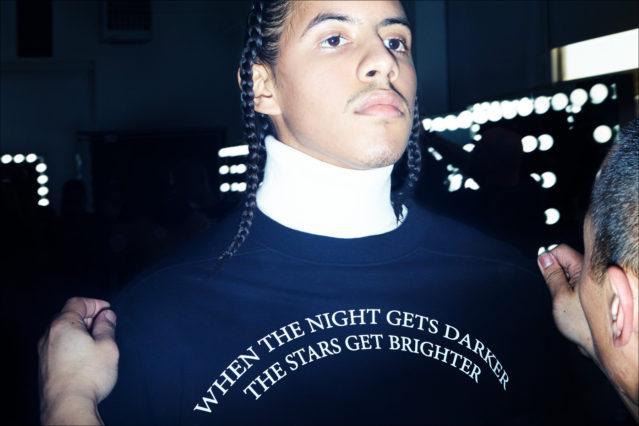 A model gets his clothing adjusted backstage at Willy Chavarria for Fall 2018. Photography by Alexander Thompson for Ponyboy magazine.