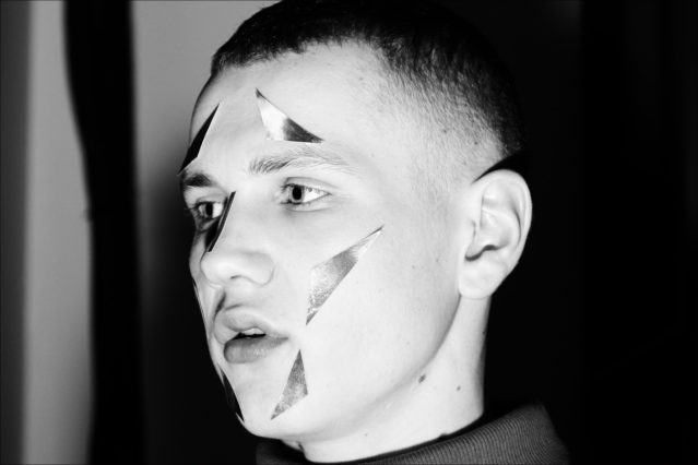 A male model backstage at the Abasi Rosborough collection for Fall 2018. Photography Alexander Thompson. Ponyboy magazine.