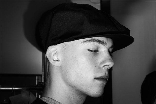 A model in a newsboy cap backstage at N. Hoolywood for Fall 2018. Photographed by Alexander Thompson for Ponyboy magazine.