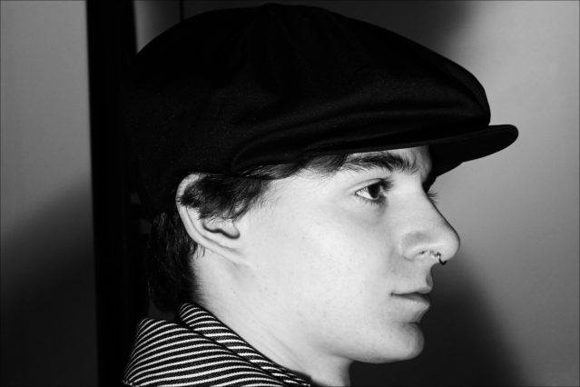 A model wears a newsboy cap backstage at N. Hoolywood for Fall 2018. Photographed by Alexander Thompson for Ponyboy magazine.